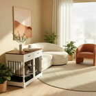 OnePaw ELARA modern living room with a white sofa, brown armchair, and a pet crate.
