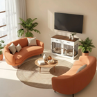 OnePaw ELARA modern living room with orange sofa, coffee table, and a pet crate.