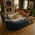 OnePaw Ares cozy living room with a blue sectional sofa, wooden coffee table, dog crate and brick fireplace.