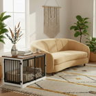 OnePaw AURELIA beige sofa in a living room with a decorative wall hanging and a pet crate.