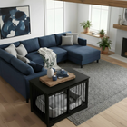 OnePaw AURELIA modern living room with a blue sectional sofa, coffee table, and pet crate.