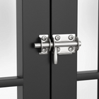 OnePaw AVENOR metallic door handle on a black door with a white background.