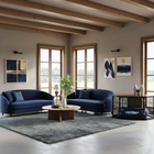 Modern living room with blue sofas, a coffee table, and a pet crate.