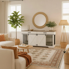 OnePaw EMBER living room with a white pet crate, sofa, coffee table, and decorative items.