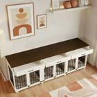 Furniture piece with pet crates and storage drawers in a room with decor elements.