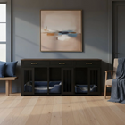 Dark wooden pet crate with blue beds against a gray wall with abstract art