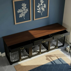 Wooden pet crates against a blue wall with framed artwork.
