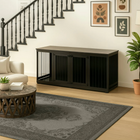 OnePaw LIVIA black pet crate in a living room with a staircase and decor elements.