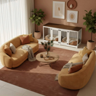OnePaw LIVIA modern living room with a curved brown sofa, coffee table, and a pet crate.