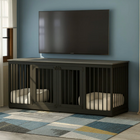 OnePaw LIVIA black pet crate with beds inside against a blue wall with a TV.