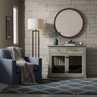 OnePaw LYRA living room with a gray armchair, wooden pet crate, and decorative items.