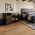 Dog lying in a wooden pet bed inside a bedroom with a bed and dresser.