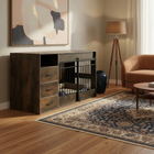 Living room with wooden dog crate, brown sofa, and abstract painting on wall.