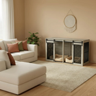 Living room with a white sofa, decorative pillows, a rug, and a wooden pet crate.