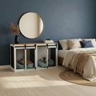Modern bedroom with a pet crate inside a cabinet, round mirror, and bed.