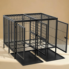 Large black metal dog crate on a beige background