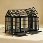 Black metal dog crate on a beige background