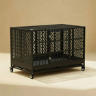 Black metal crate with wheels on a beige background