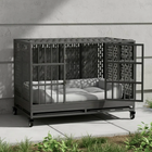 Modern outdoor pet crate piece with a metal frame and cushioned seat on a patio.