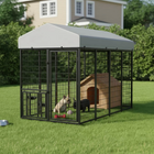 Large outdoor dog kennel with a roof, mesh sides, and a dog house inside on grass.