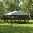 Large outdoor dog kennel with a gray roof in a grassy area with trees.
