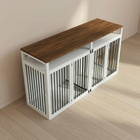 A pet crate with wooden top and metal grille design against a plain wall.