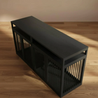 Black wooden and metal dog crate on a wooden floor