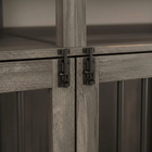 Close-up of a wooden cabinet with a metal hinge on a neutral background