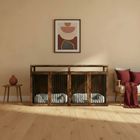 Wooden pet crate in a room with a sofa and decorative items.