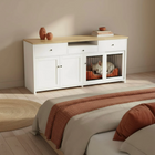 White entertainment console with pet crate in a bedroom setting