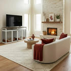 Modern living room with furniture style pet crate a fireplace, white sofa, and television.