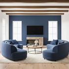 OnePaw SELENE modern living room with blue curved sofas, a coffee table, and a wooden pet crate.