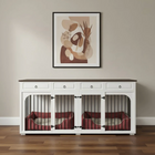 White cabinet with pet kennels on a wooden floor, framed artwork on the wall.