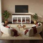 Living room with white armchairs, a coffee table, and a pet crate