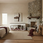 Modern bedroom with stone fireplace, wooden desk, and pet crate.