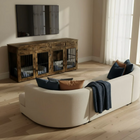 Living room with a white sofa, wooden pet crate, and TV.