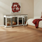 Dog kennels integrated into a bedroom setting with a bed and artwork on the wall.