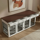 Furniture piece with pet crate design on a wooden floor, featuring a painting on the wall.
