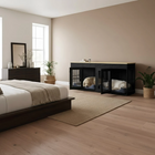 Modern bedroom with a black pet crate and two dogs inside, wooden floor, and neutral walls.