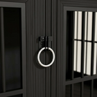 Close-up of a black metal door with a white doorknob.