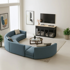 OnePaw Vesta modern living room with a blue sectional sofa, coffee table, and furniture style pet crate.